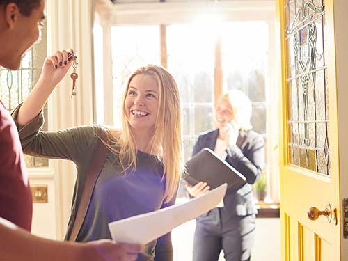 Couple hold the keys to their new house after a successful building inspection.